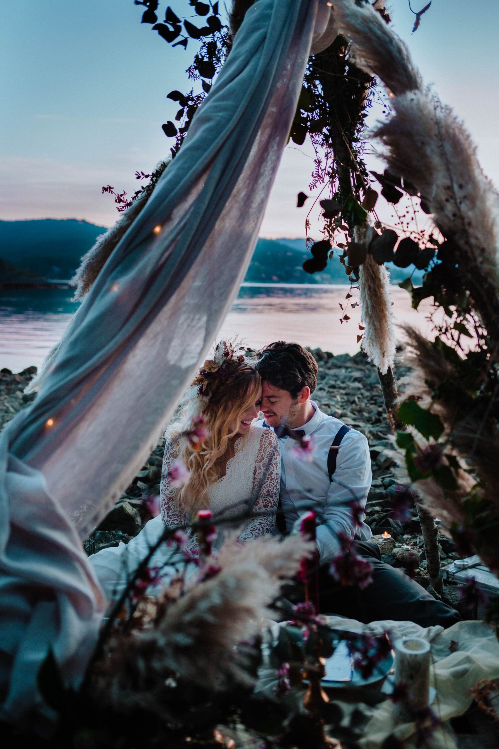 couple eloping on the beach under a teepee during sunset - Victoria BC