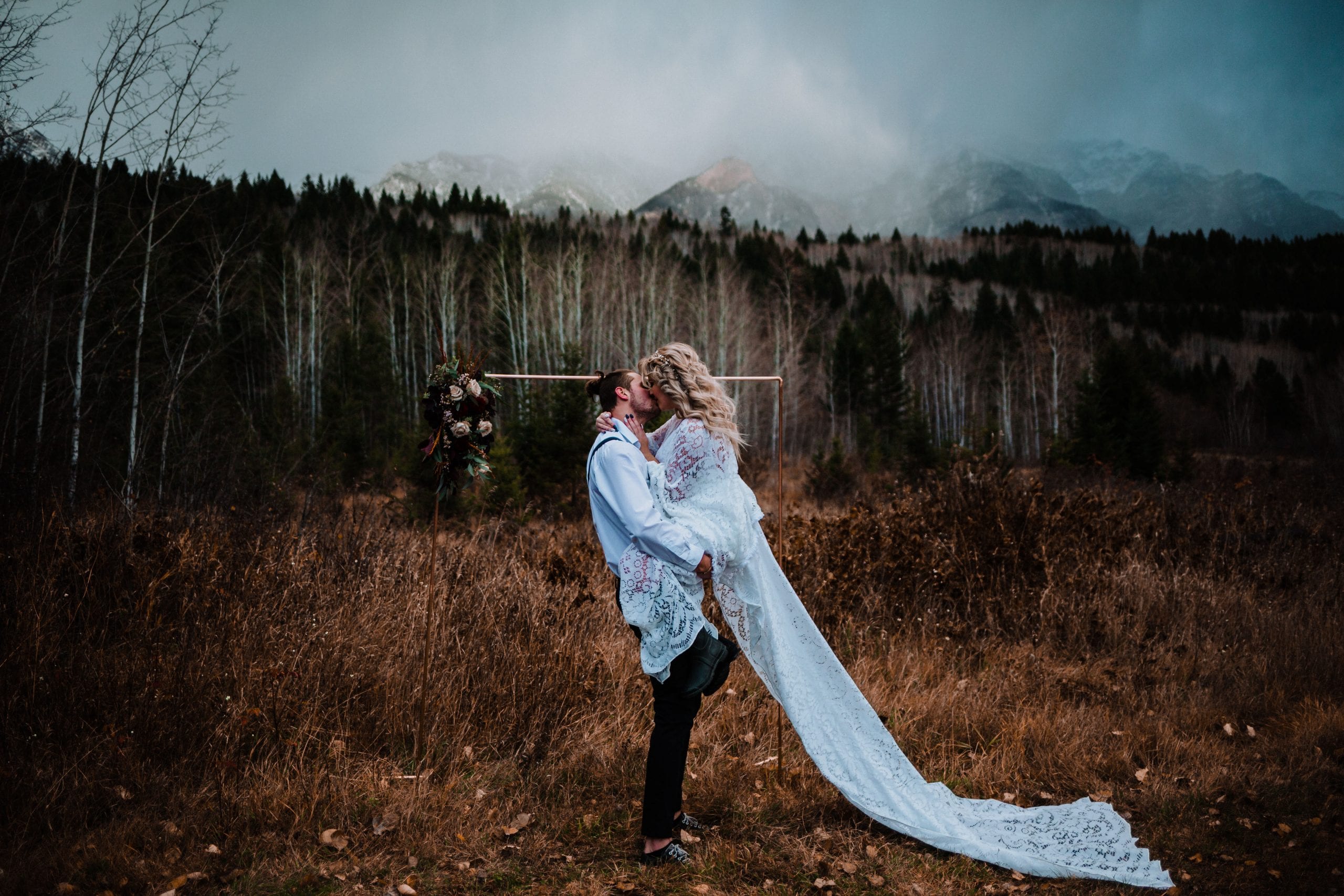 Eloping couple kissing in the mountains in Golden BC