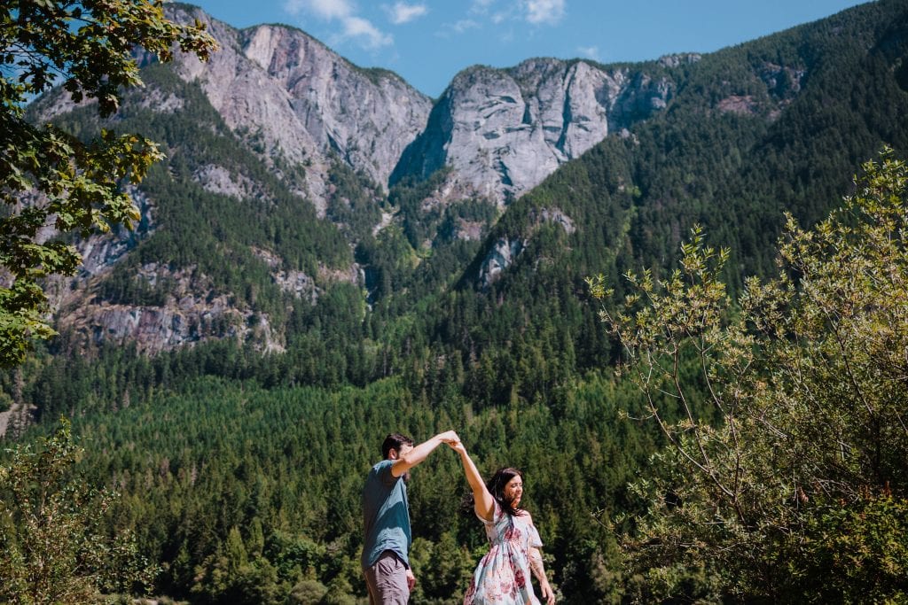 Couple in Hope BC dancing in the mountains during their engagement photo session