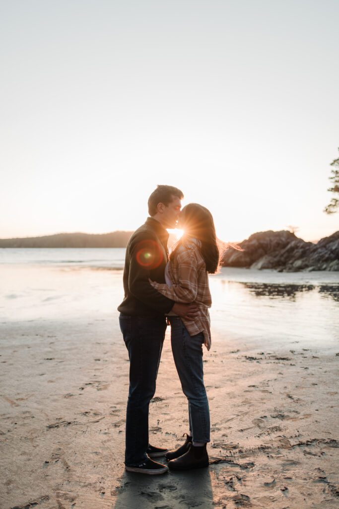 A couple kissing on Tonquin Beach, one of the best Tofino beaches for your photo session